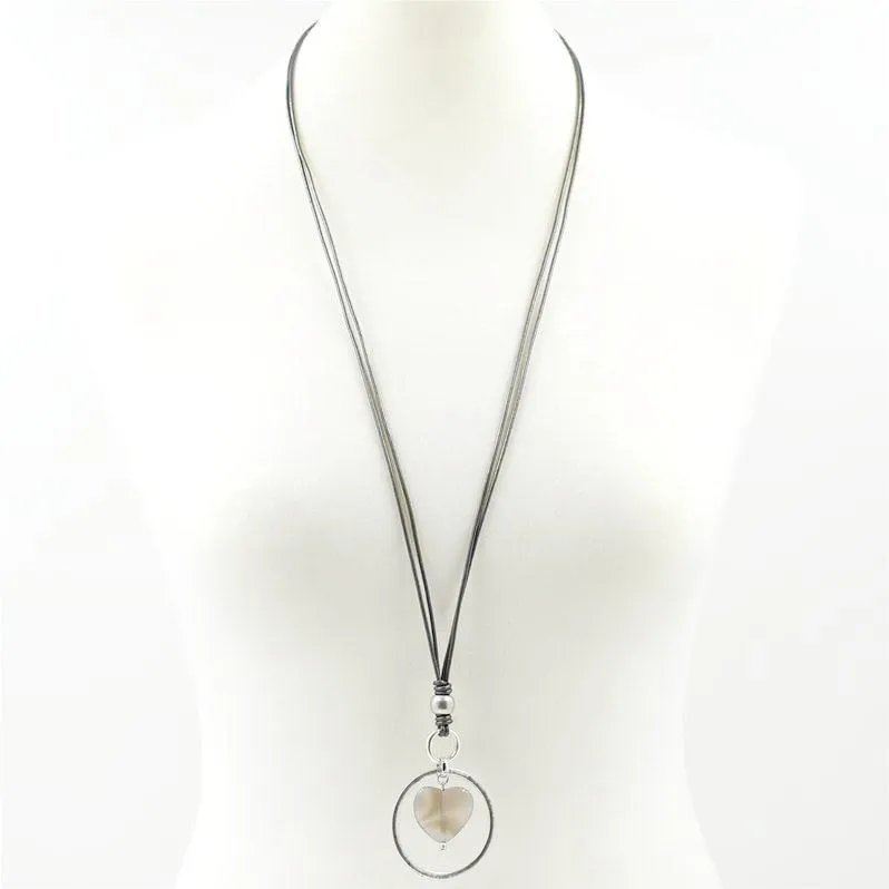 Agate stone within circle pendant on long leather necklace
