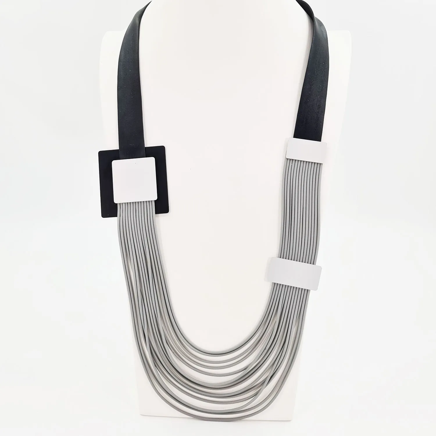 Fine multi strand neoprene mid length necklace with square elements